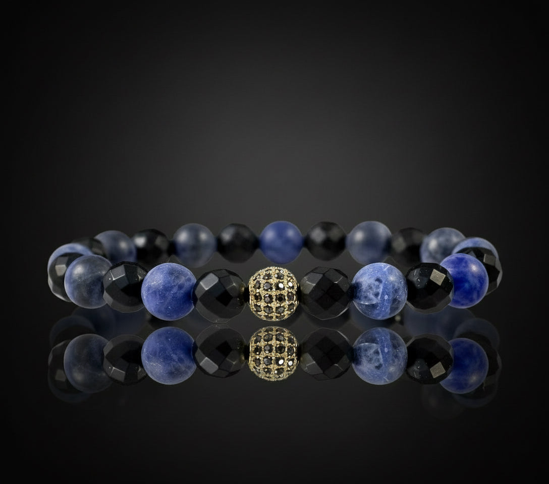 Handcrafted Bluemenite black agate and blue sodalite disco bracelet on wrist