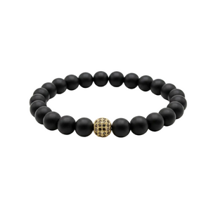 A beaded stretch bracelet featuring matte black round beads and a central gold-toned textured accent bead, displayed on a clean white background.