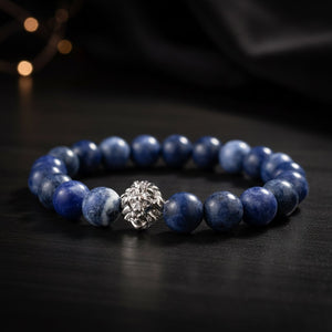 Blue beaded bracelet with a silver clasp on a dark background